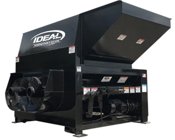 A large industrial trash compactor with an open hopper and dual fans.